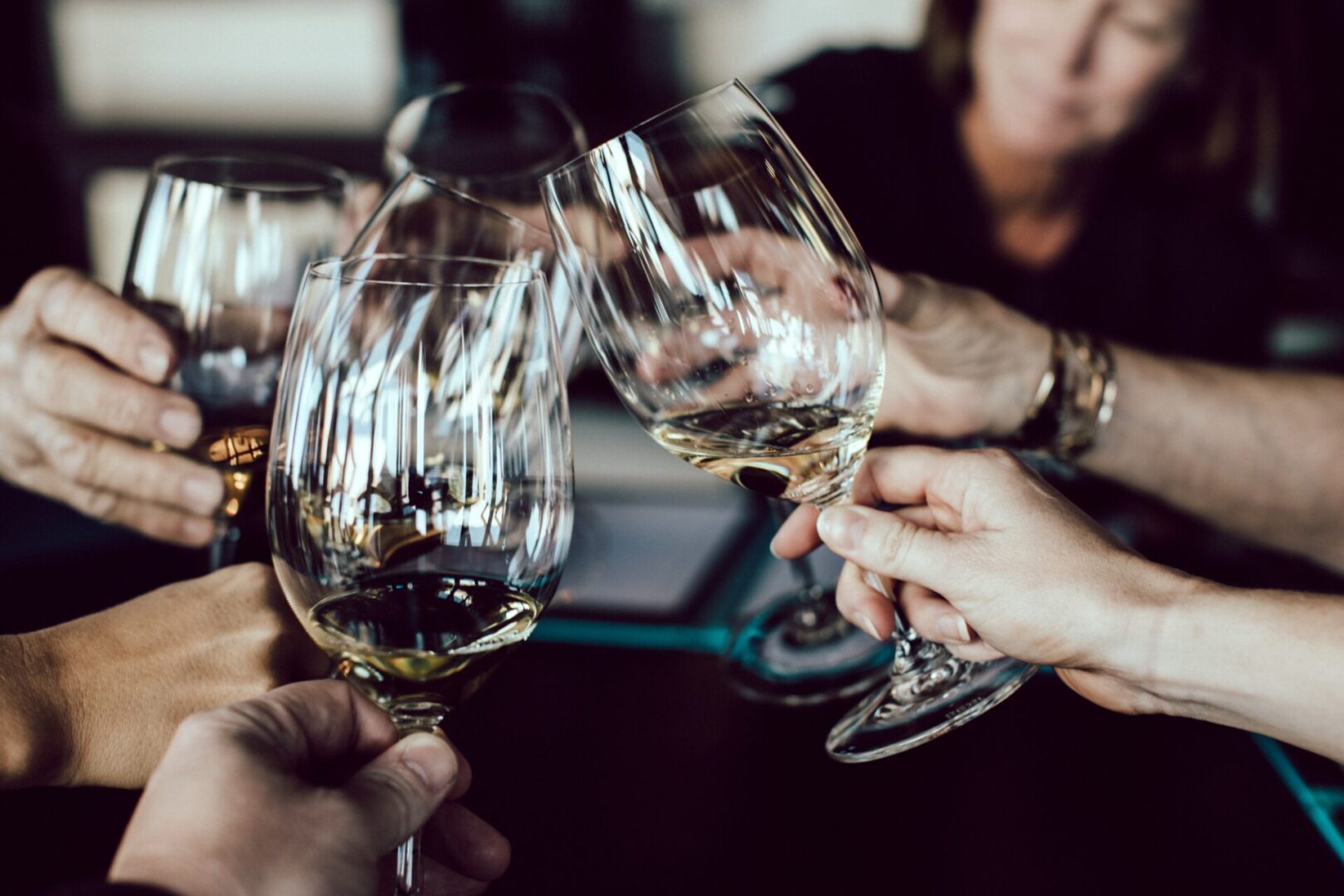 A group of people holding wine glasses in their hands.