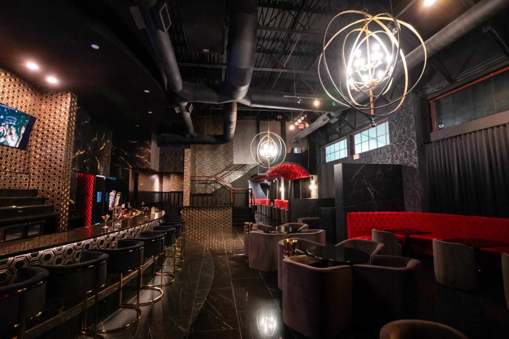 The interior of a luxury lounge in black and red.