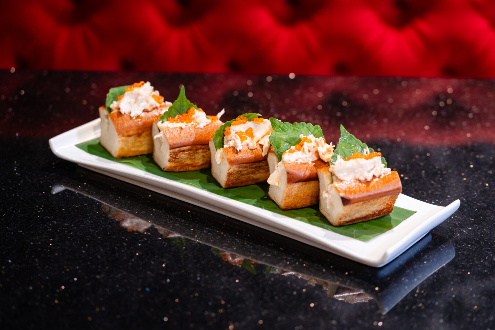 A tray of appetizers on a table in a luxury lounge.