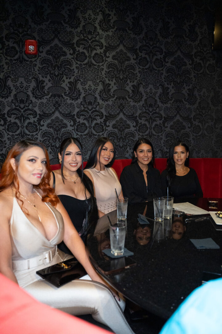 A group of women sitting around a table in a luxury lounge.